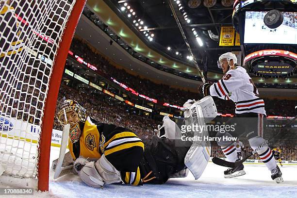 Jonathan Toews of the Chicago Blackhawks celebrates a goal by Patrick Kane in the second period against Tuukka Rask of the Boston Bruins in Game Four...