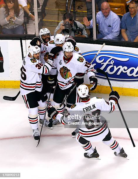 Marcus Kruger of the Chicago Blackhawks celebrates with teamates after a goal in the second period against the Boston Bruins in Game Four of the 2013...