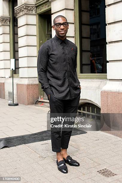 Singer Tinie Tempah wears an Yves Saint Laurent top and Dolce Gabbana trousers on day 2 of London Collections: Men on June 17, 2013 in London,...