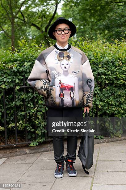 Student Chan Woojeng wears a Juun J Top, H&M Trousers and Nike trainers on day 2 of London Collections: Men on June 17, 2013 in London, England.