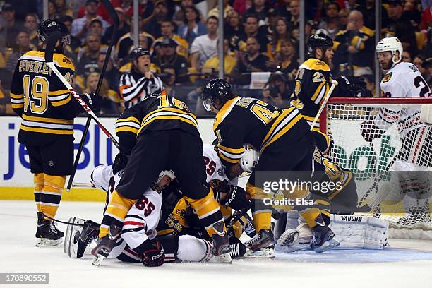 Kaspars Daugavins and Torey Krug of the Boston Bruins defend in front of the net against Andrew Shaw and Viktor Stalberg Chicago Blackhawks in Game...