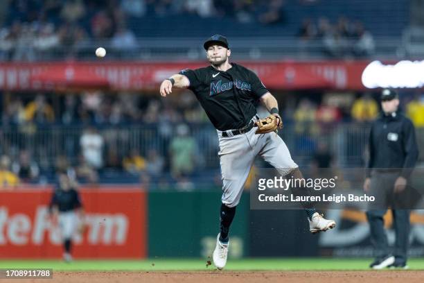 Garrett Hampson of the Miami Marlins throws out Bryan Reynolds of the Pittsburgh Pirates at first during the ninth inning of the game at PNC Park on...