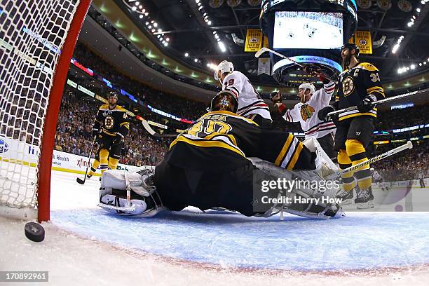 Bryan Bickell and Jonathan Toews of the Chicago Blackhawks celebrate after Brent Seabrook k scores the game winning goal against Tuukka Rask of the...