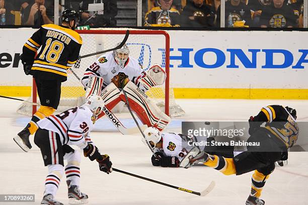 Johnny Boychuk of the Boston Bruins shoots the puck and scores a goal against the Chicago Blackhawks in Game Four of the Stanley Cup Final at TD...