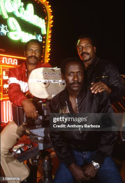 Group portrait of American actors Fred Williamson, Richard Roundtree, and Jim Brown on the set of their film 'One Down Two to Go' , 1976.