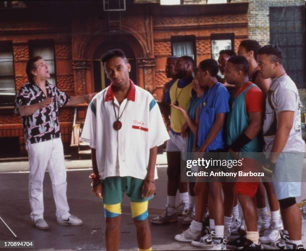 Portrait of American film director and actor Spike Lee on the set of his film 'Do the Right Thing,' New York, 1989. Among the cast behind him is...