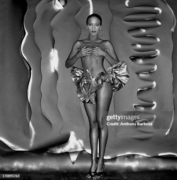 Portrait of American fashion model Toukie Smith she poses, topless, with her hands over her chest, New York, New York, early 1980s.