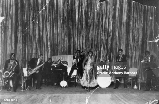 American blues and jazz vocalist Bessie Smith performs on stage with her band, Philadelphia, Pennsylvania, circa 1920.