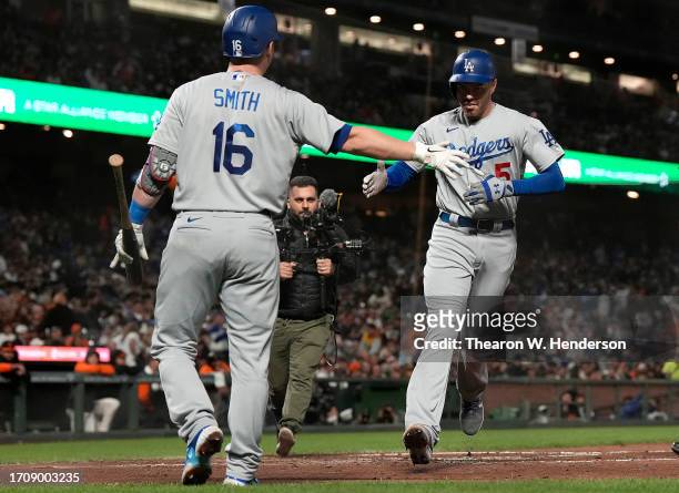 Freddie Freeman of the Los Angeles Dodgers is congratulated by Will Smith after Freeman hit a solo home run against the San Francisco Giants in the...