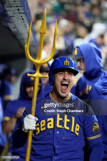 Josh Rojas of the Seattle Mariners celebrates his solo home run with the trident prop during the third inning against the Texas Rangers at T-Mobile...