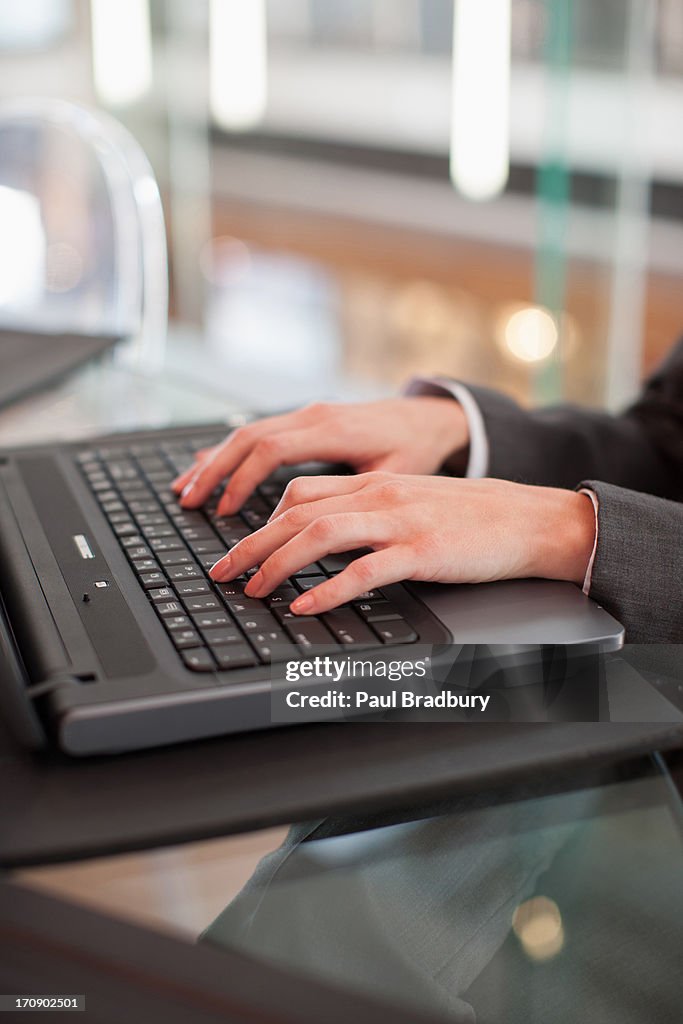 Businesswoman typing on laptop