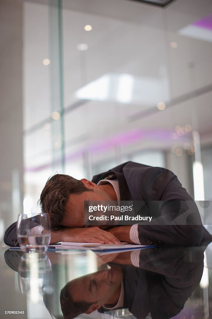 Businessman sleeping at desk in office