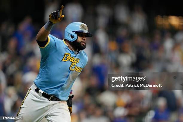 Carlos Santana of the Milwaukee Brewers celebrates after driving in the game winning run against the Chicago Cubs in the 10th inning at American...