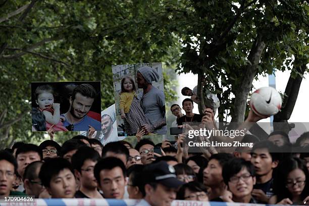 Fans wait outside the cordon during David Beckham's visit to Tongji University on June 20, 2013 in Shanghai, China.