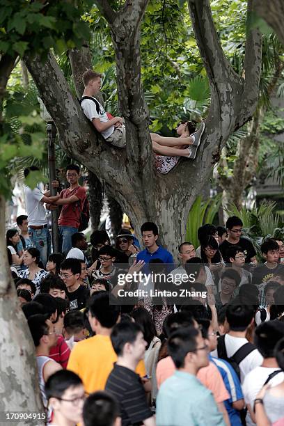 Fans wait outside the cordon during David Beckham's visit to Tongji University on June 20, 2013 in Shanghai, China.