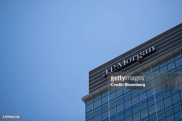 Signage for JPMorgan Chase & Co. Is displayed on a building in the business district of Central in Hong Kong, China, on Wednesday, June 19, 2013....