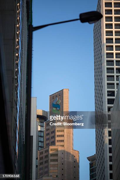 The Standard Chartered Bank building, center, stands in the business district of Central in Hong Kong, China, on Wednesday, June 19, 2013. Chief...