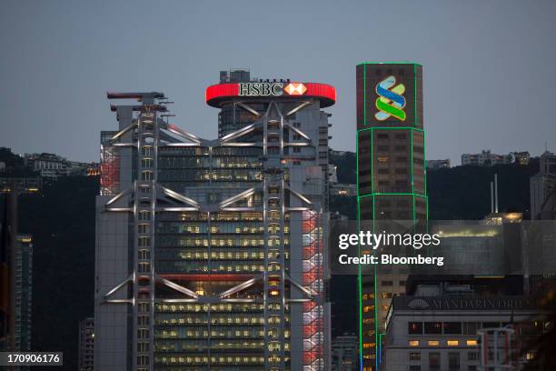 The HSBC Holdings Plc headquarters, left, stands next to the Standard Chartered Bank building in the business district of Central in Hong Kong,...