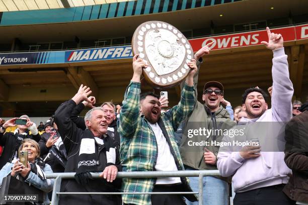 Fans celebrate with the Ranfurly Shield during the round nine Bunnings Warehouse NPC match between Wellington and Hawke's Bay at Sky Stadium, on...