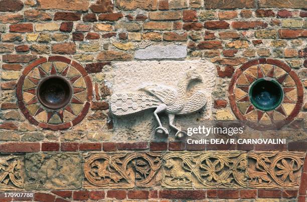 Pavone, relief on the facade of Pomposa Abbey, Codigoro, Emilia-Romagna, Italy.