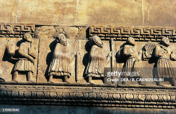Pilgrims along Via Francigena, sculpture details from the facade of the Cathedral of San Donnino , Fidenza, Emilia-Romagna, Italy.