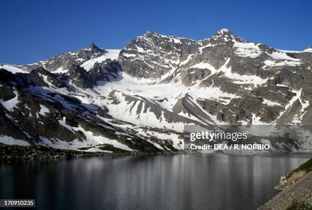 Lake Serru' and Cima della Vacca, Orco Valley, Gran Paradiso National Park, Piedmont, Italy.