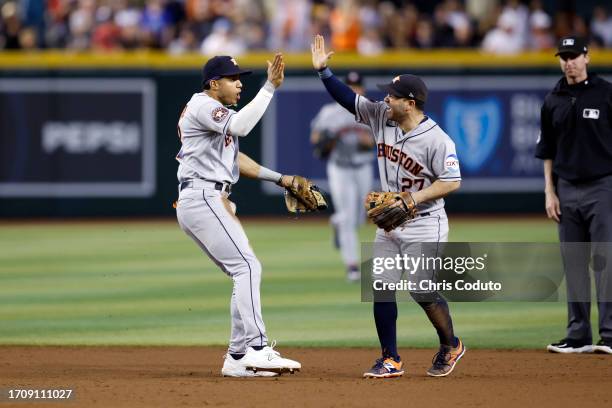 Jose Altuve of the Houston Astros reacts with Jeremy Pena after the final out during the eighth inning against the Arizona Diamondbacks at Chase...