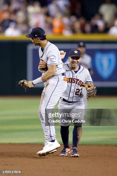 Jose Altuve of the Houston Astros reacts with Jeremy Pena after the final out during the eighth inning against the Arizona Diamondbacks at Chase...