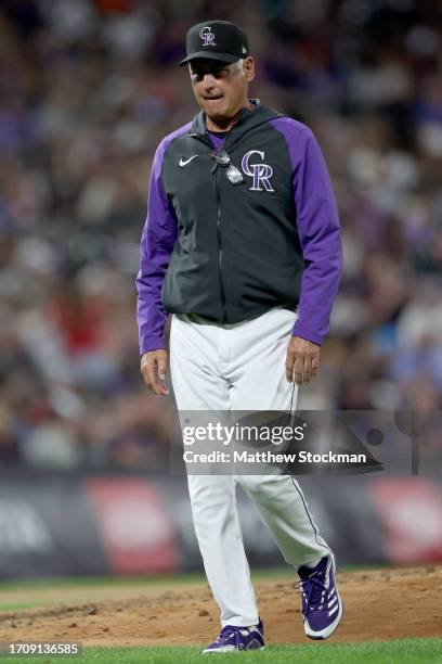 Manager Bud Black of the Colorado Rockies leaves the mound after changing pitchers against the Minnesota Twins in the seventh inning at Coors Field...