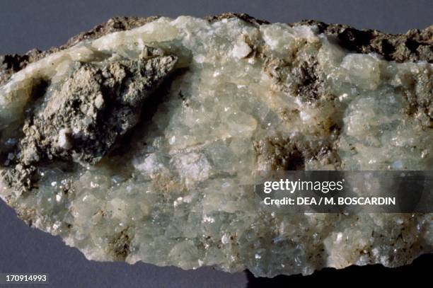 Green Prehnite, silicate, on volcanic rock.