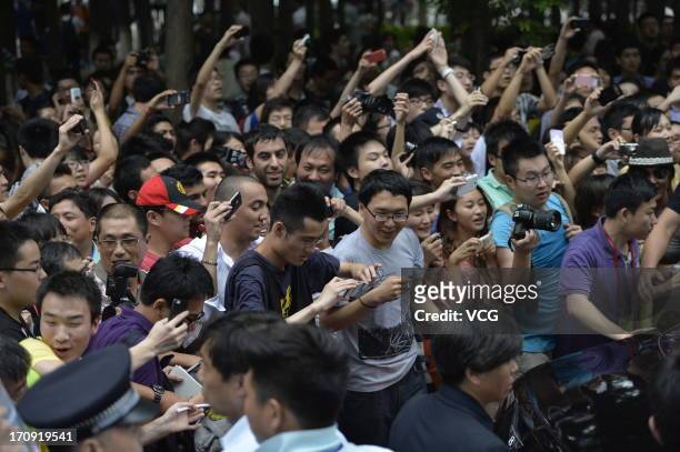 Fans cheer as David Beckham arrives at Tongji University on June 20, 2013 in Shanghai, China.