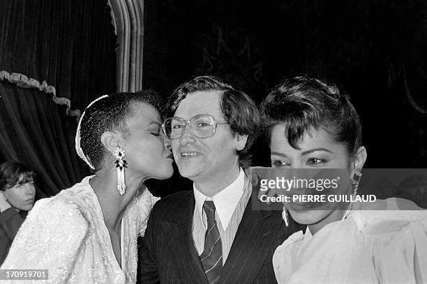 French fashion designer Jean-Louis Scherrer is congratulated by models in Paris on January 24, 1983 after presenting his spring-summer haute couture...