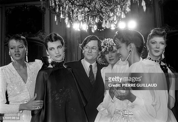 French fashion designer Jean-Louis Scherrer is congratulated by models in Paris on January 24, 1983 after presenting his spring-summer haute couture...