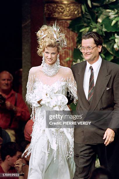 French fashion designer Jean-Louis Scherrer walks with his daughter Laetitia, in Paris on July 27, 1992 during the presentation of his fall/winter...