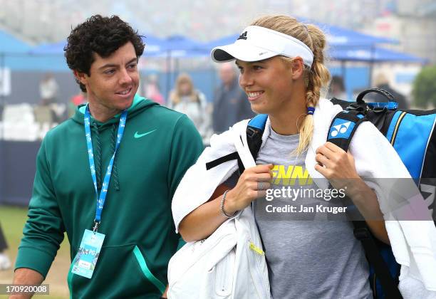 Rory McIlroy and girlfriend Caroline Wozniacki leave the practice court during day six of the AEGON International tennis tournament at Devonshire...