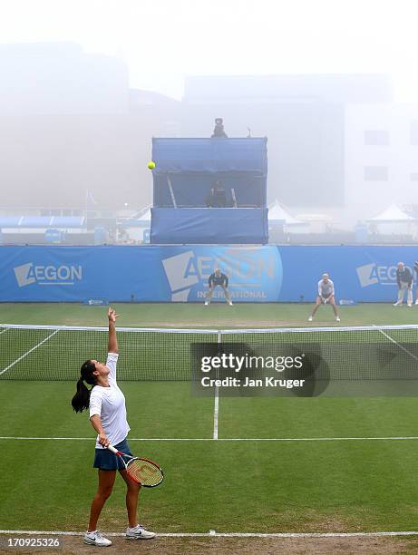 Jamie Hampton of the USA serves in the mist against Lucie Safarova of Czech Republic during day six of the AEGON International tennis tournament at...