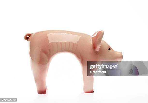 suffering piggy bank side view on white - slank stockfoto's en -beelden