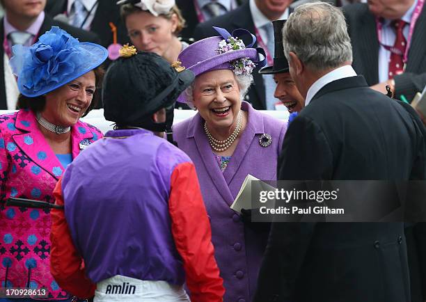 Queen Elizabeth II laughs with Jockey Ryan Moore and trainer Sir Michael Stoute after the Queen's horse Estimate won The Gold Cup on Ladies' Day...