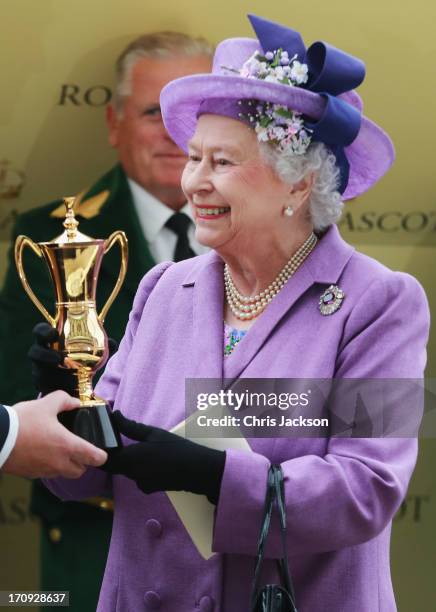 Queen Elizabeth II holds the Gold Cup after Ryan Moore riding Estimate won The Gold Cup during Ladies' Day on day three of Royal Ascot at Ascot...