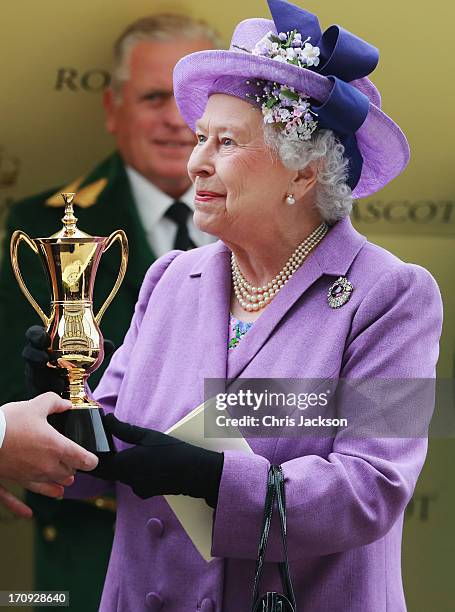 Queen Elizabeth II holds the Gold Cup after Ryan Moore riding Estimate won The Gold Cup during Ladies' Day on day three of Royal Ascot at Ascot...