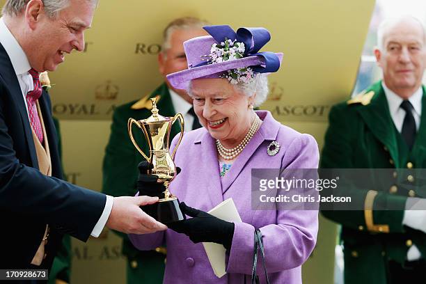 Queen Elizabeth II holds the Gold Cup and Prince Andrew, Duke of York after Ryan Moore riding Estimate won The Gold Cup during Ladies' Day on day...