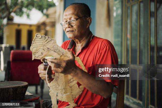 java, making shadow puppet, wayang kuli or shadow puppet - east asian works of art specialist stock pictures, royalty-free photos & images