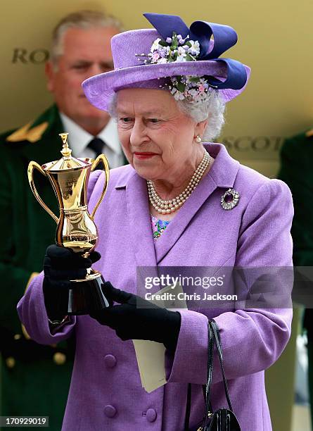 Queen Elizabeth II holds the Gold Cup after Ryan Moore riding Estimate won The Gold Cup during Ladies' Day on day three of Royal Ascot at Ascot...