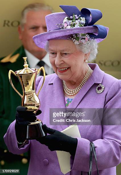 Queen Elizabeth II holds the Gold Cup after Ryan Moore riding Estimate won The Gold Cup during Ladies' Day on day three of Royal Ascot at Ascot...