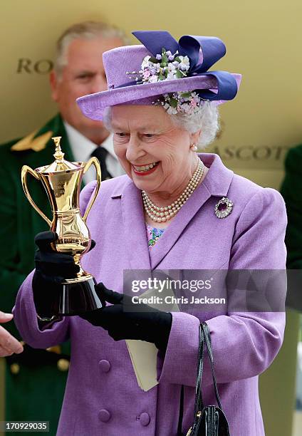 Queen Elizabeth II holds the Gold Cup after Ryan Moore riding Estimate won The Gold Cup during Ladies' Day on day three of Royal Ascot at Ascot...