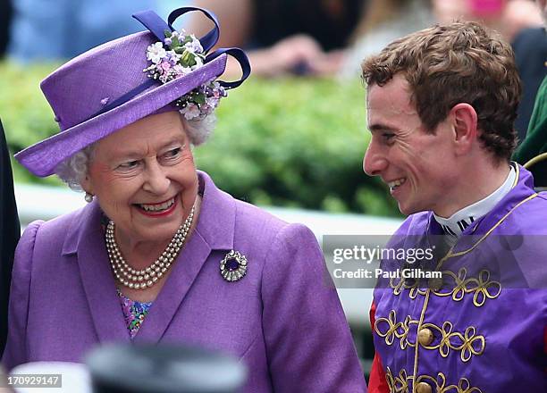 Queen Elizabeth II talks with Jockey Ryan Moore after the Queen's horse Estimate won The Gold Cup on Ladies' Day during day three of Royal Ascot at...