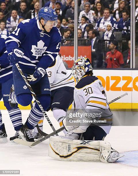 Toronto Maple Leafs left wing James van Riemsdyk leaps out of the way in front of Buffalo Sabres goalie Ryan Miller in first period action as the...