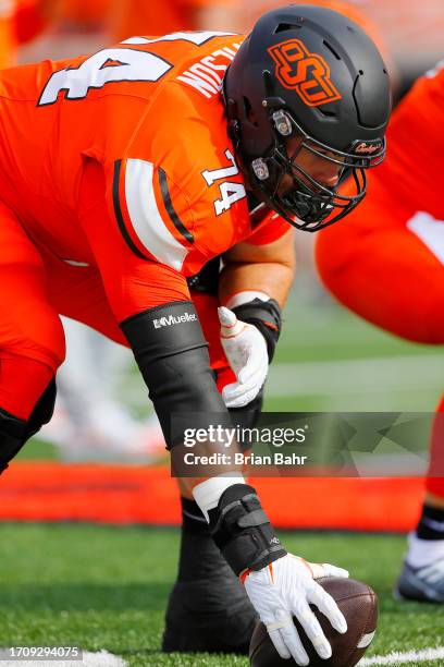 Center Preston Wilson of the Oklahoma State Cowboys snaps the ball before a game against the South Alabama Jaguars at Boone Pickens Stadium on...