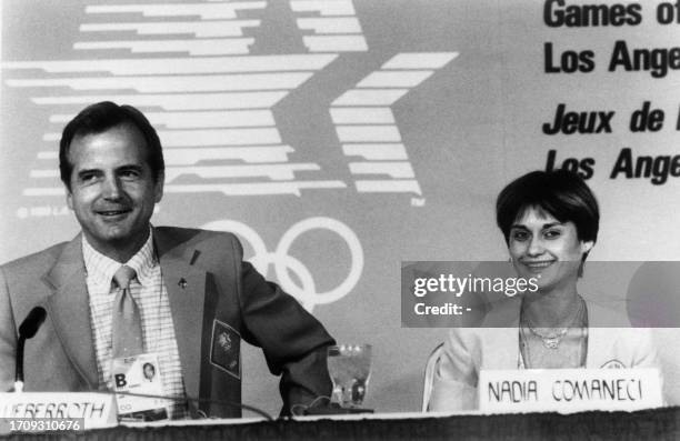 Olympic Organizing Committee chairman Peter Ueberroth and Romanian former gymnast and Olympic gold medalist Nadia Comaneci attend a press conference...
