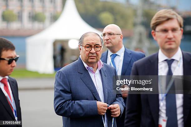 Alisher Usmanov, Russian billionaire owner of USM Holdings Ltd., center, leaves following a Bloomberg Television interview on the opening day of the...